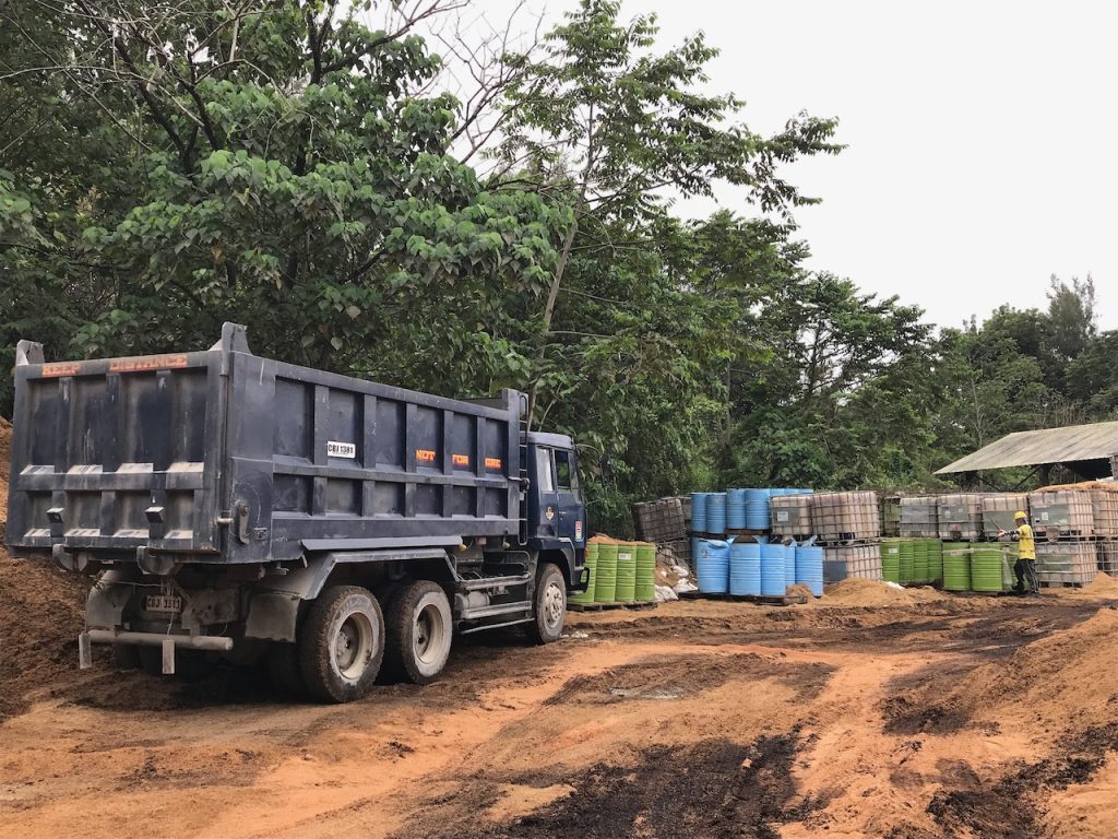 Dump truck loading and unloading IBC tanks and barrels in Visayas